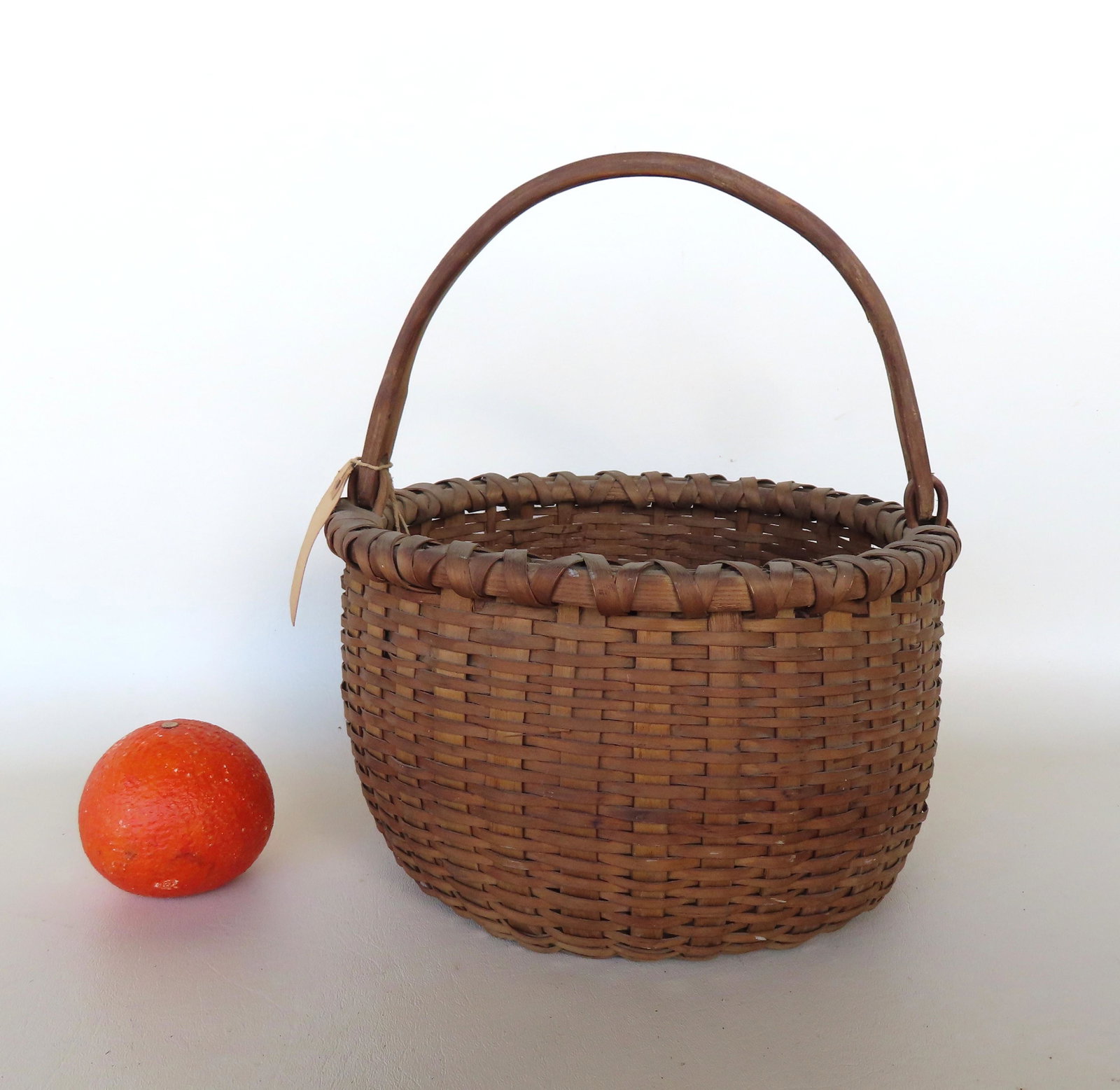 A small Taughkanic swing handle basket. The rim is wrapped in a criss-cross pattern, has notched (1 of 6)