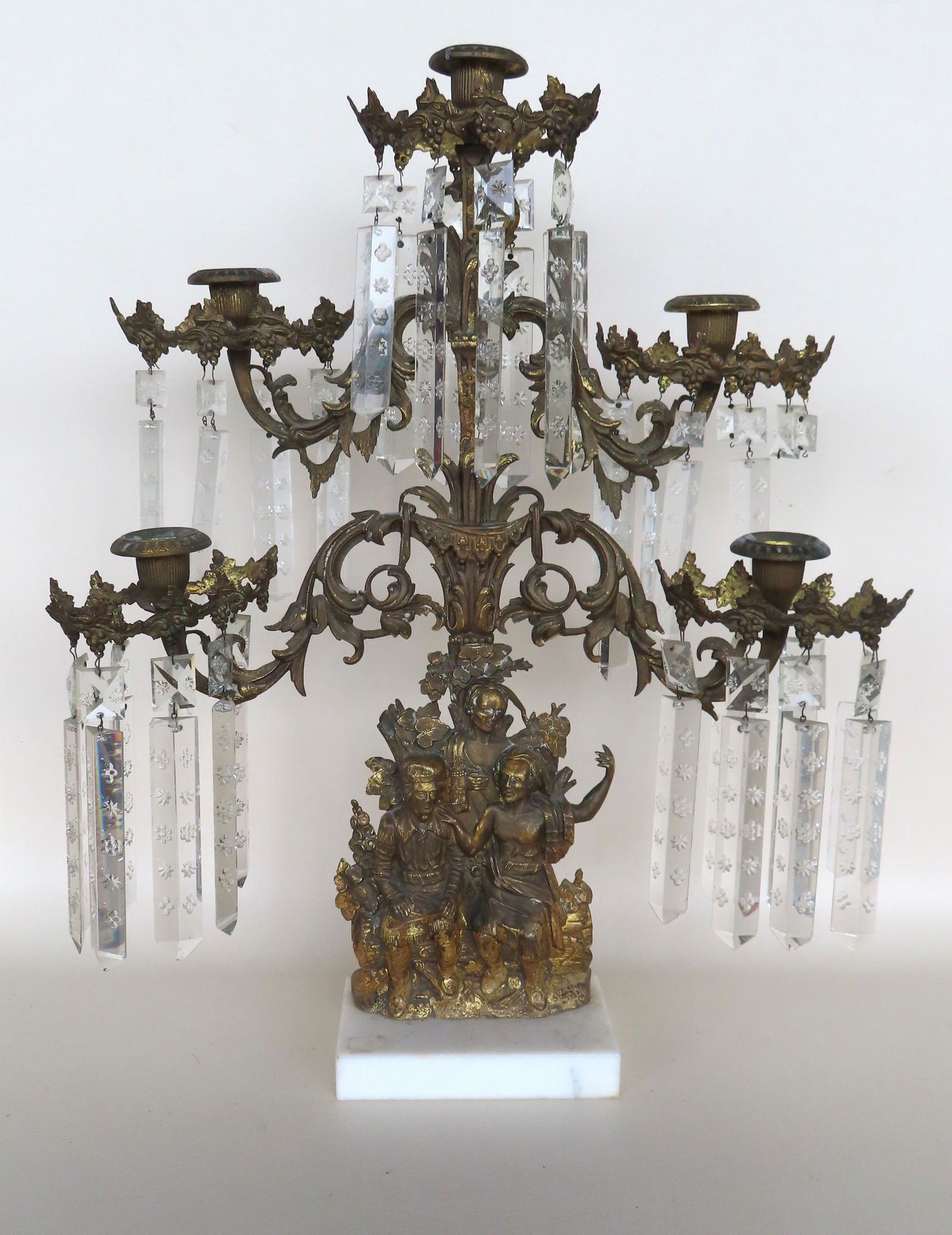 A Large ornate girandole with 5 candle fonts mounted on guilded brass arms, etched prisms and (1 of 6)