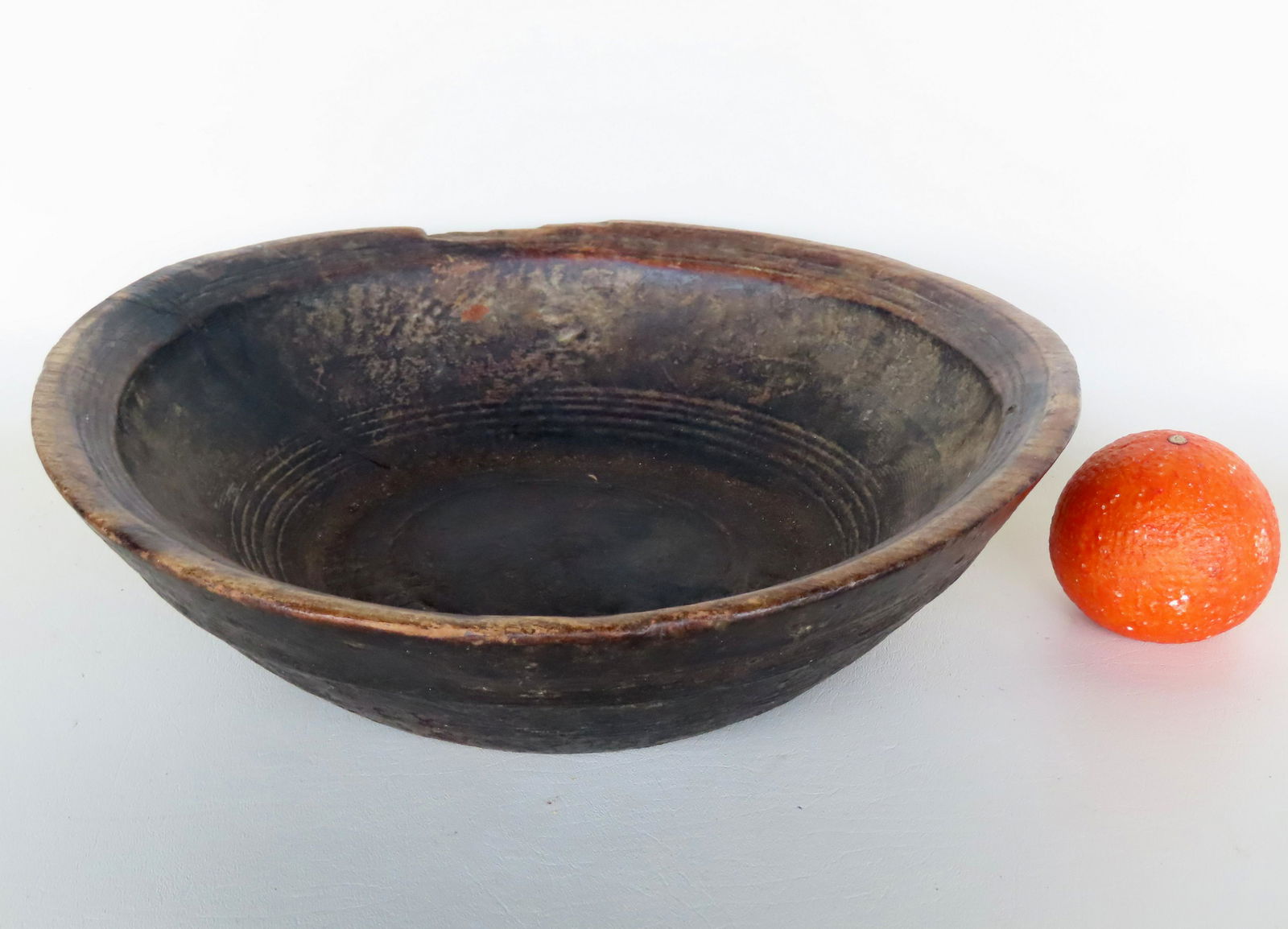 A very early primitive bowl with layers and remnants of old crusty paint and having a molded rim and (1 of 7)