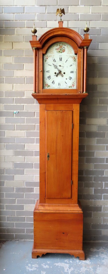 An American maple and birch tall case clock with arched top having brass finials flanking the (1 of 20)