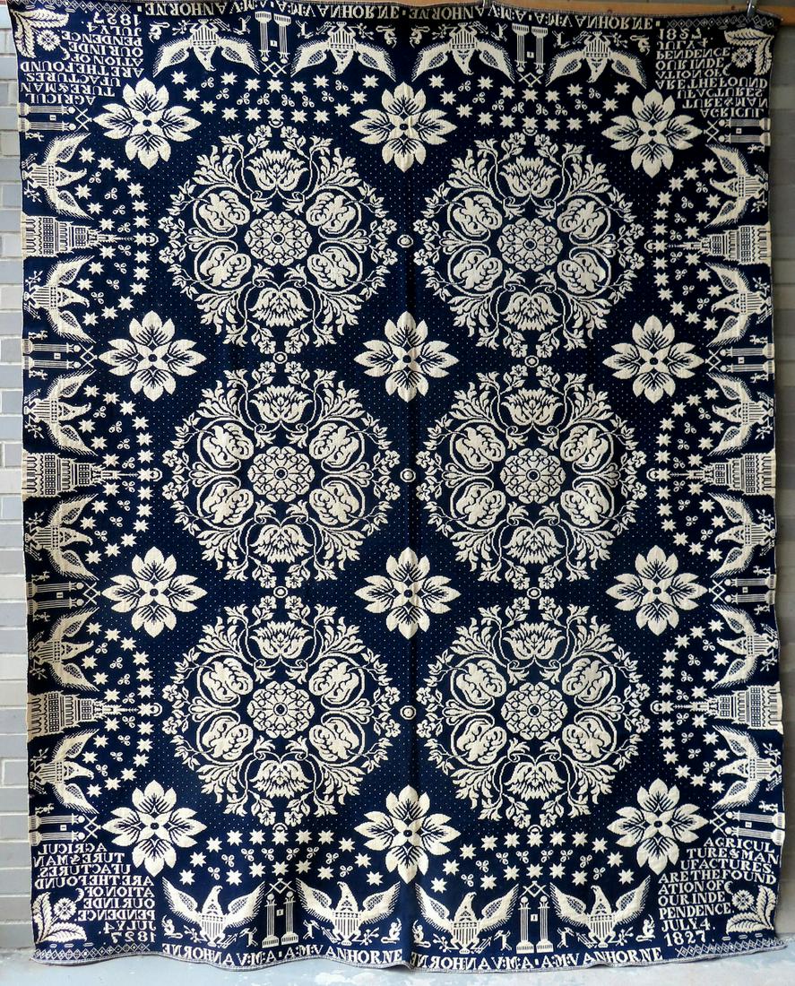 A spectacular Jacquard blue and white coverlet signed along the edge of top and bottom borders "A.M. (1 of 9)