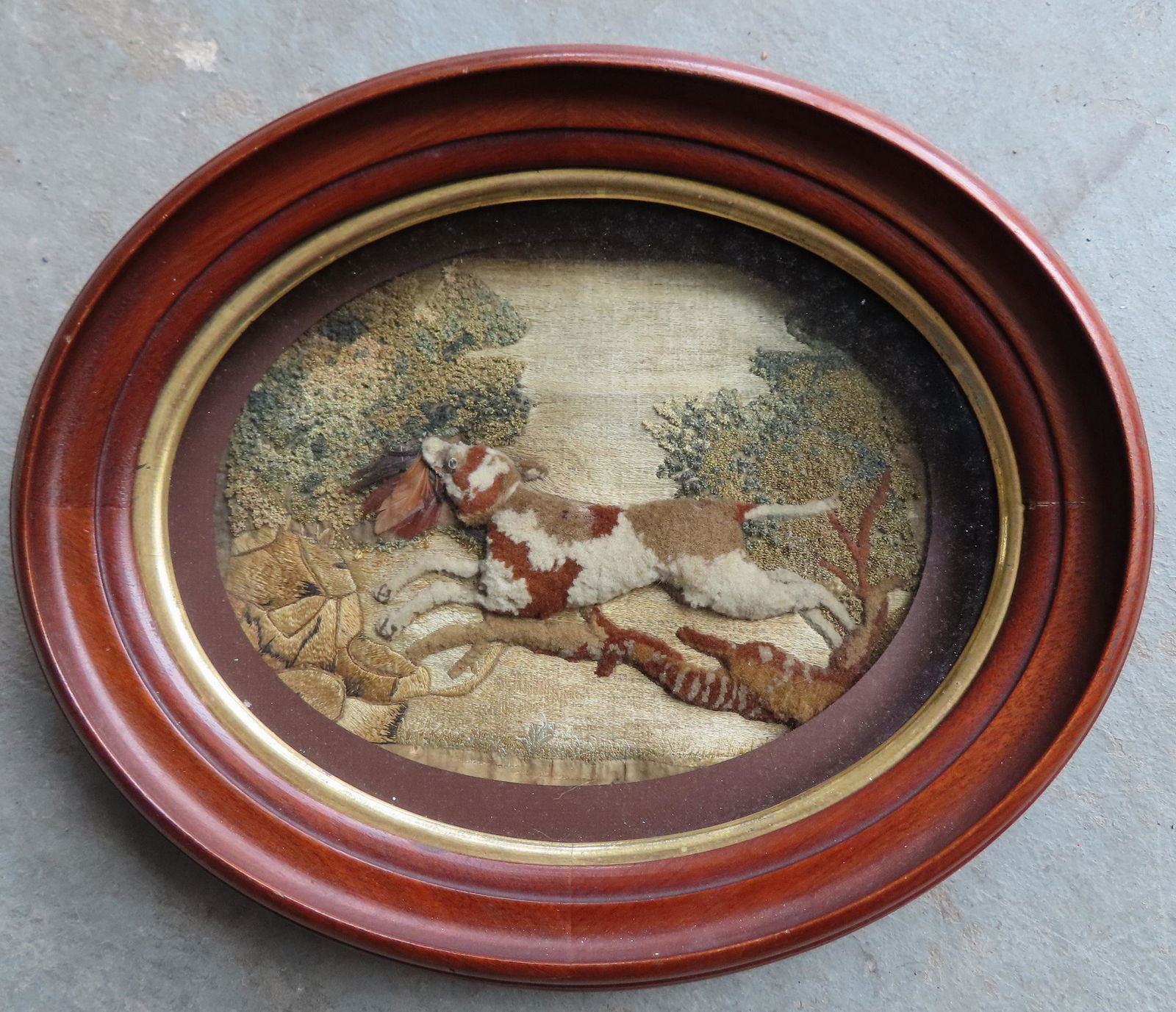 An unusual stump work embroidery on silk depicting a dog running through woods with game bird in (1 of 2)