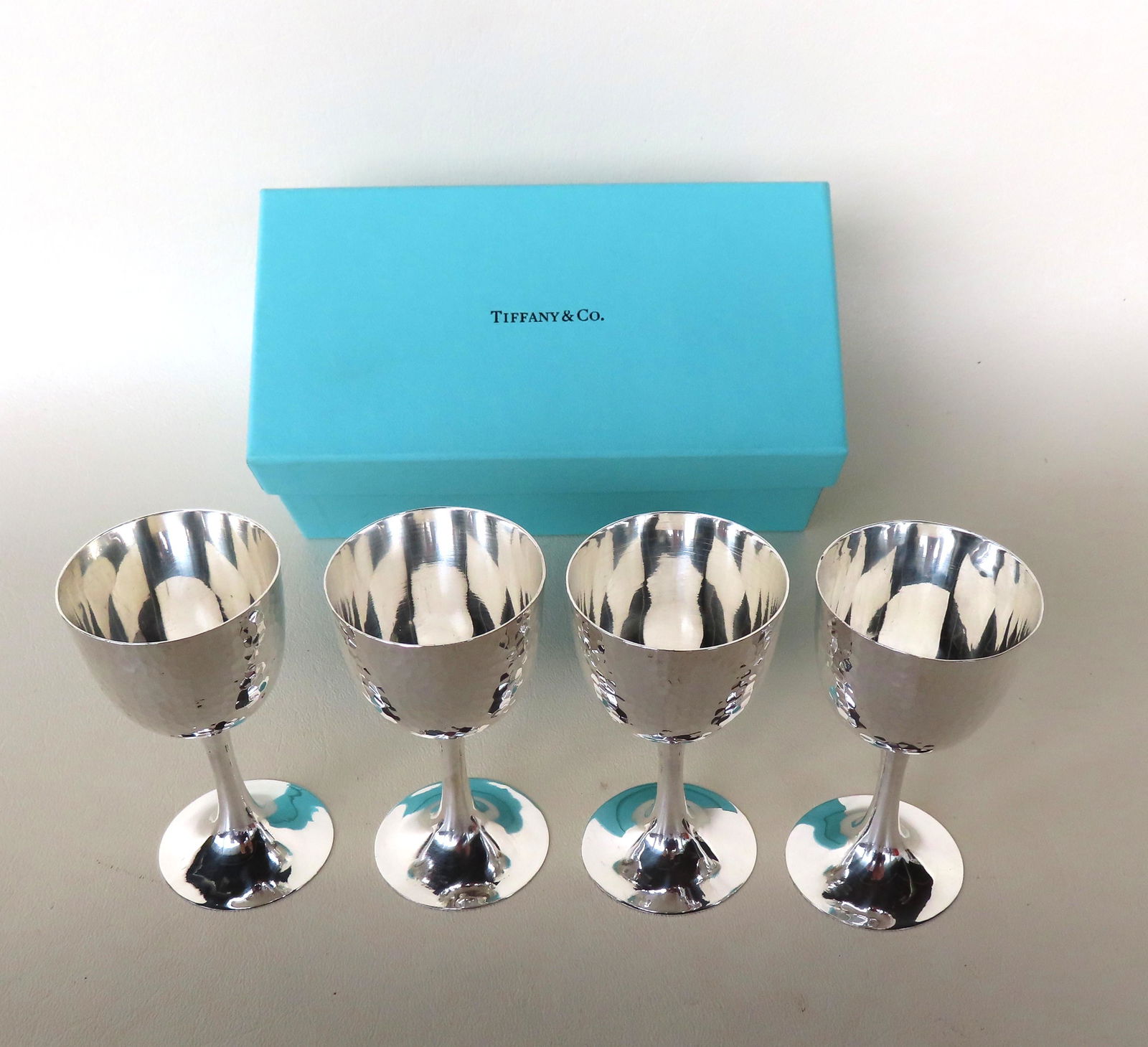 Grouping of 4 Tiffany & Co. hand hammered sterling cordials in original box, late 20th century. Each (1 of 6)