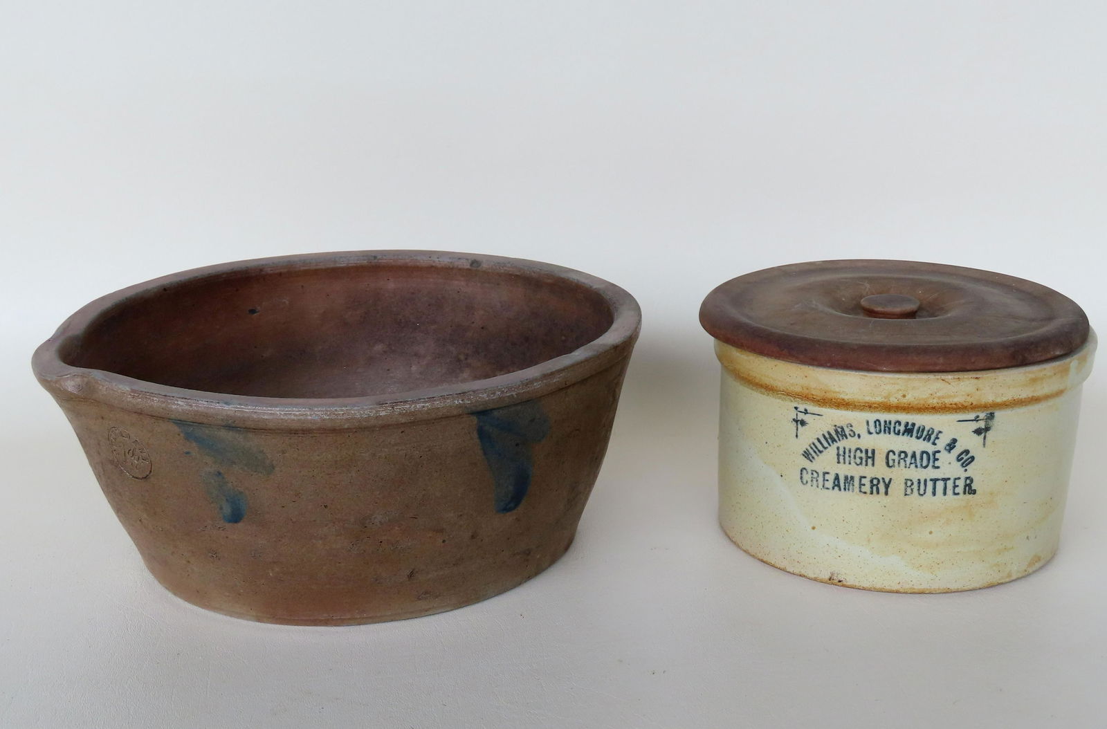 Two butter crocks. The first, labeled in blue paint "WILLIAMS, LONGMORE & CO. / High Grade Creamery (1 of 7)