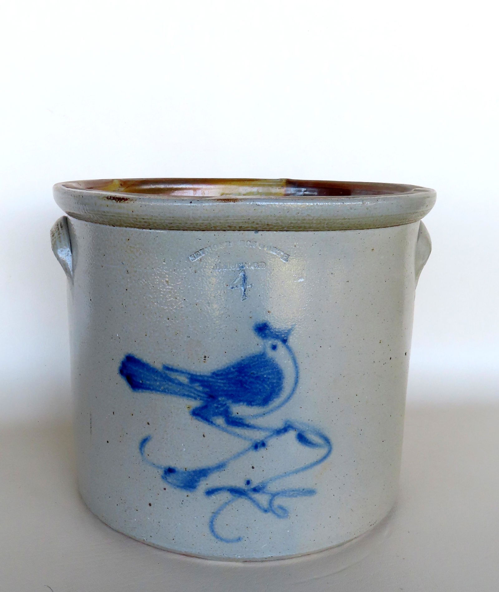 A stoneware crock, 4 gallon, decorated with a cobalt blue bird on branch with the impressed mark of (1 of 6)