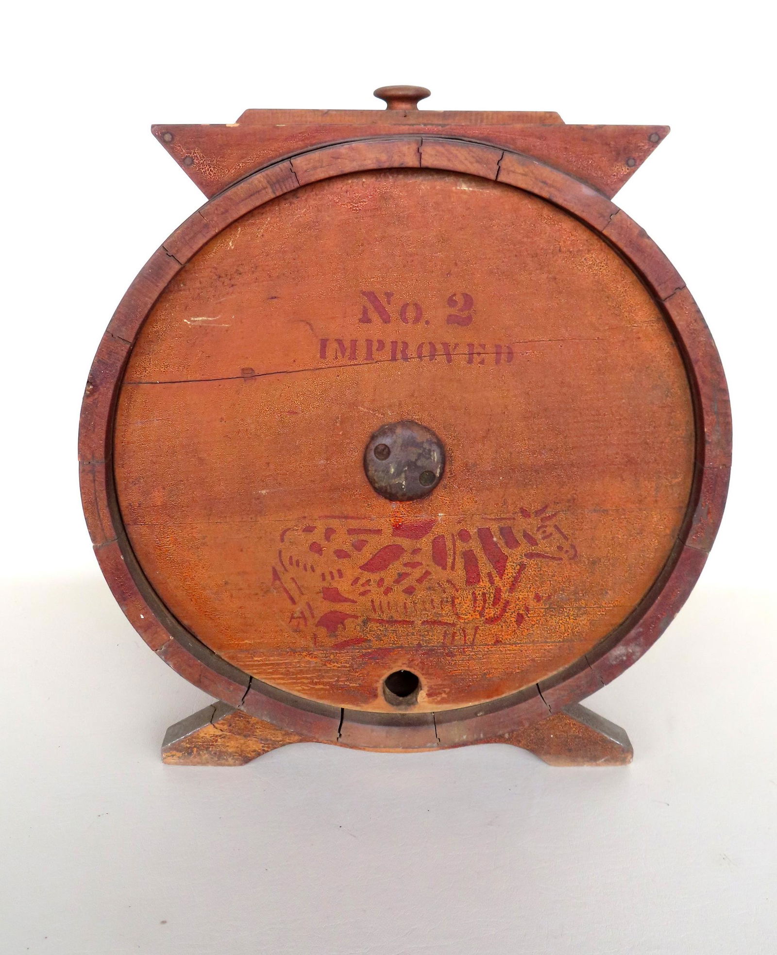 A table top butter churn marked "No. 2 Improved" with a stenciled image of cow on one side and the (1 of 6)