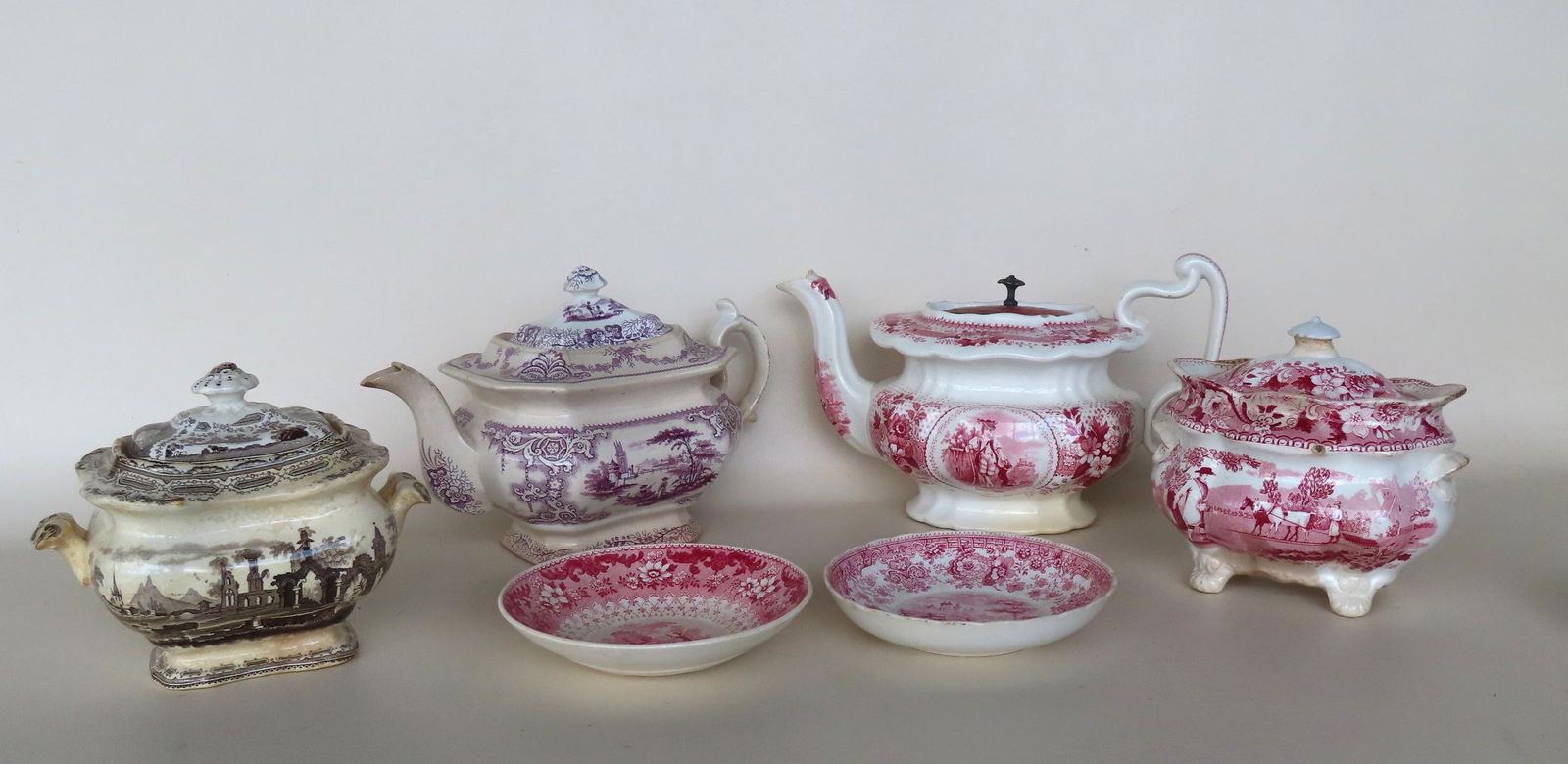 A grouping of near matching Staffordshire transferware china including 2 teapots, and 2 covered (1 of 12)