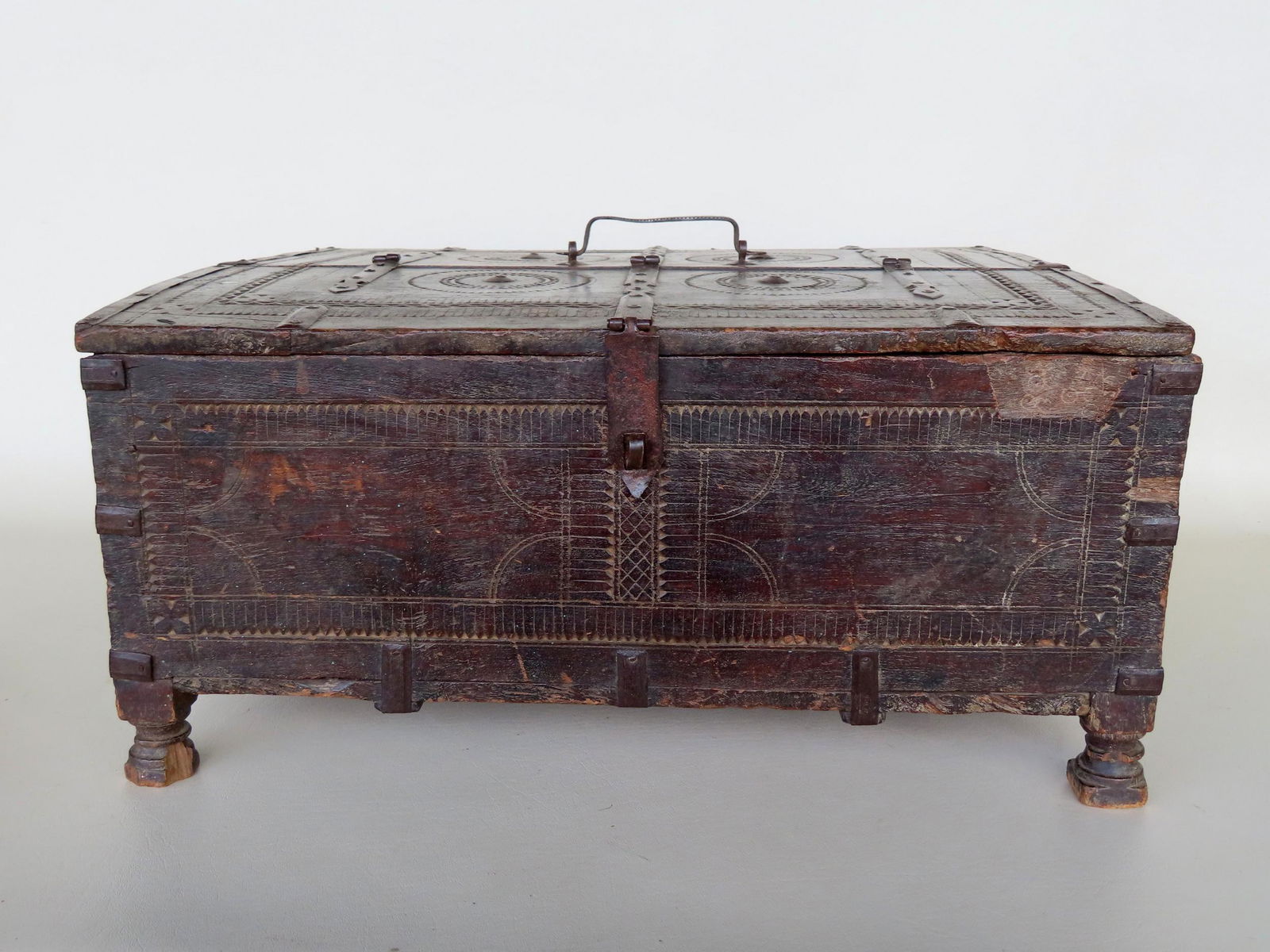 A primitive continental 18th century storage box with carvings on all sides, hand forged iron straps (1 of 14)