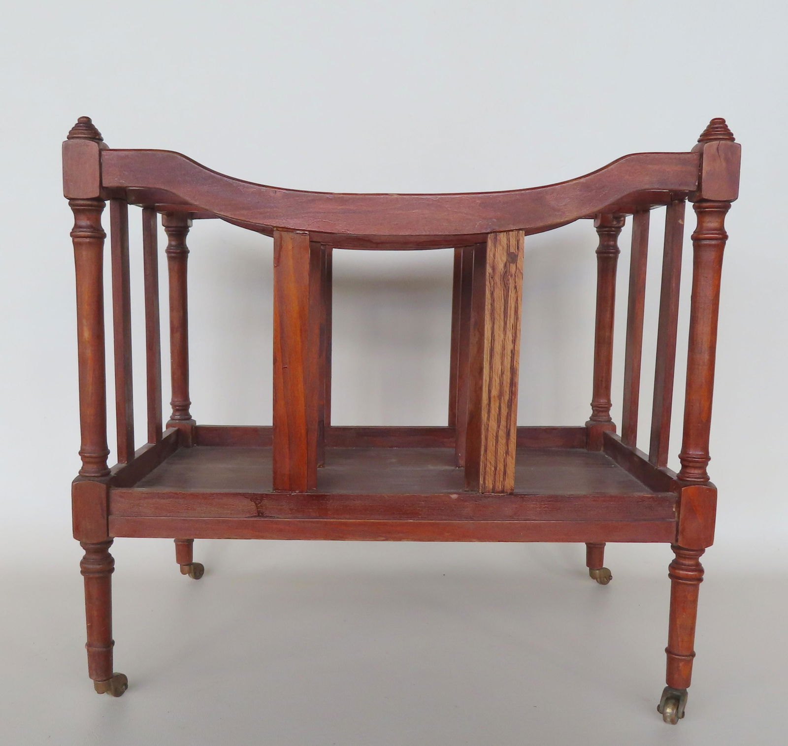 A Sheraton magazine stand, appears to be poplar wood construction and mounted on brass casters. Some (1 of 4)