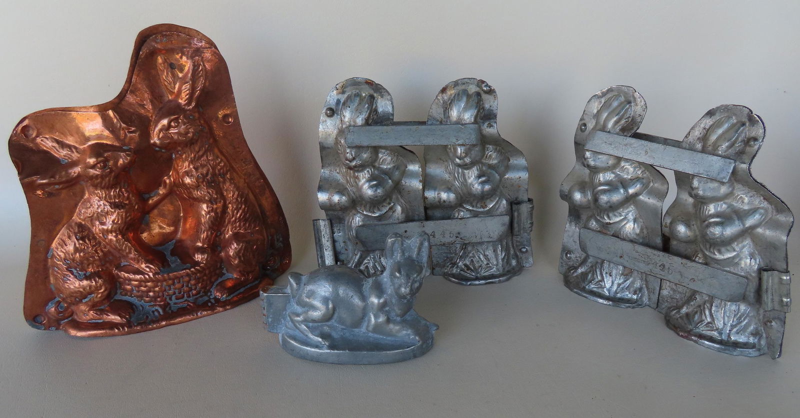 Four metal Easter Bunny chocolate molds, the largest in copper measuring 7 1/2"x 7 3/4"(missing (1 of 6)