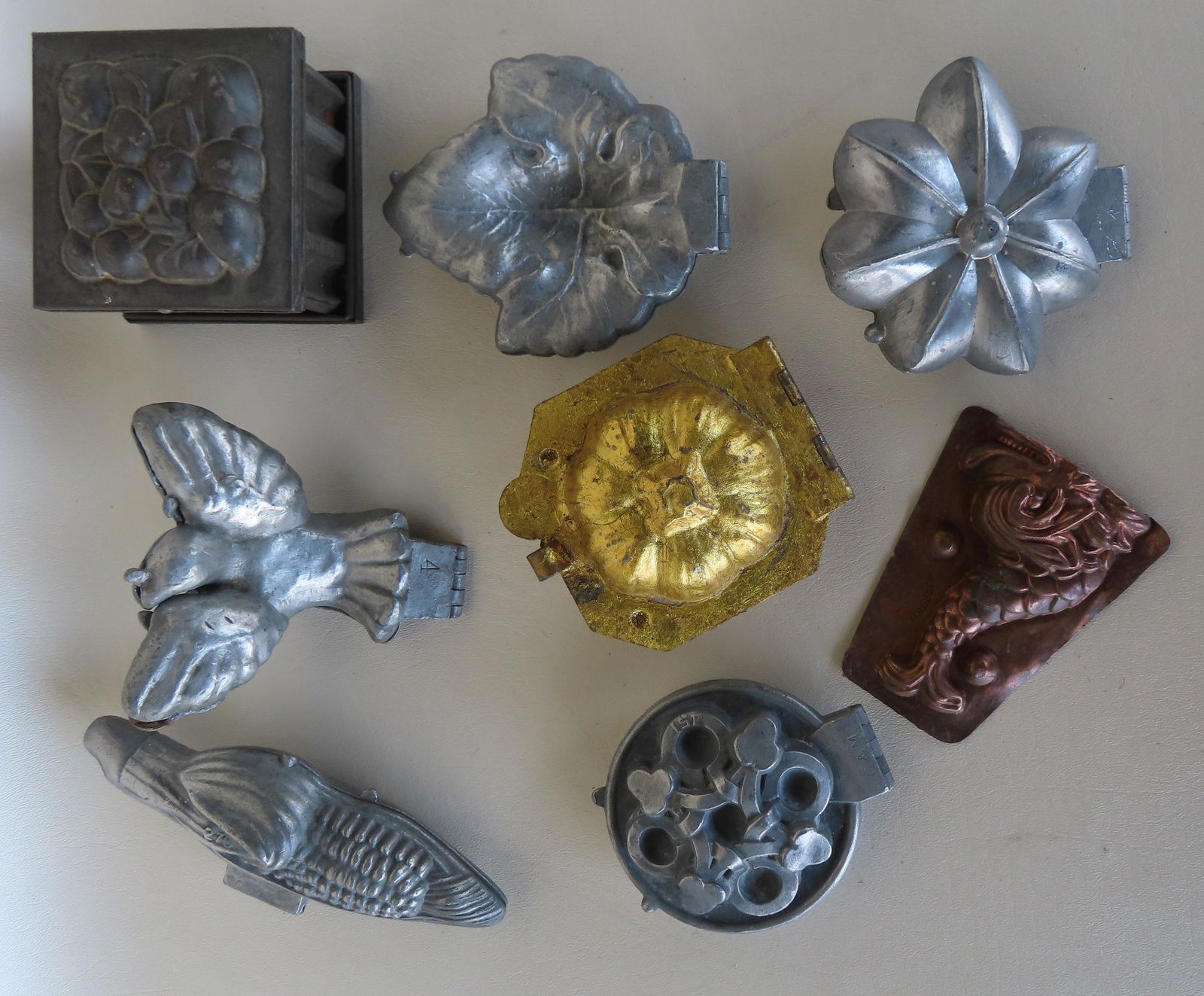 Grouping of ice cream and chocolate molds, including 2 unusual forms of a dove and an ear of corn. (1 of 10)