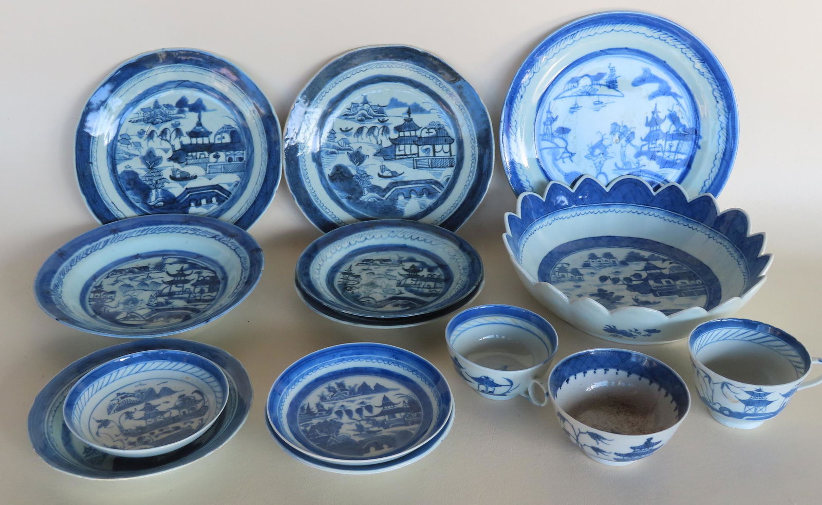 Grouping of Chinese Canton blue and white plates, saucers, and bowl, most with chips and hairlines. (1 of 17)