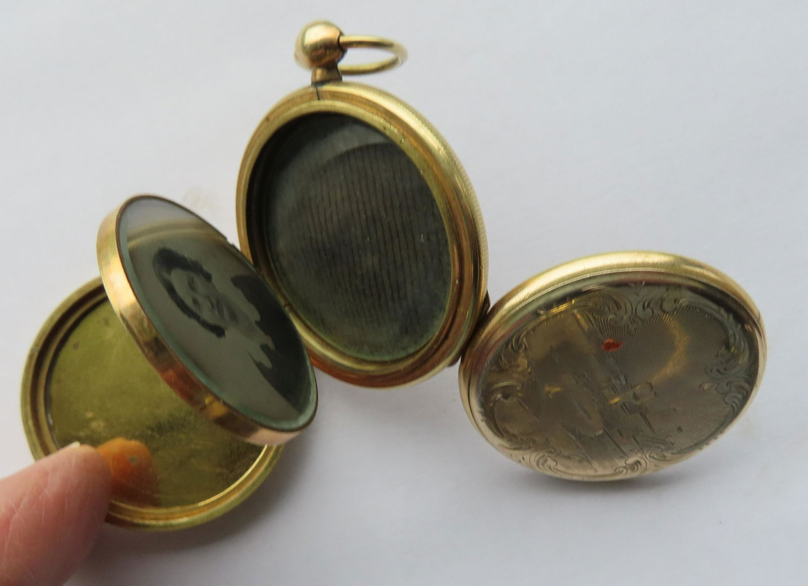 An unusual engraved gold filled pocket watch photo locket containing 4 foldout tintypes (slots for 6 (1 of 7)