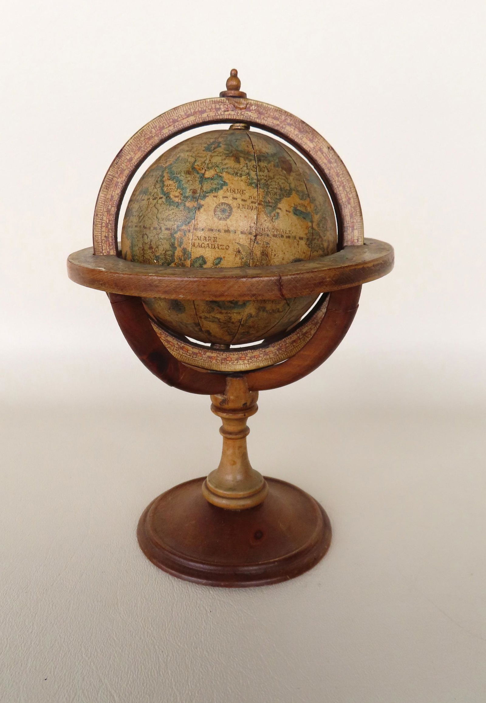 A small wooden terrestrial globe on stand - applied lithograph paper on orb and orb holder, the (1 of 7)