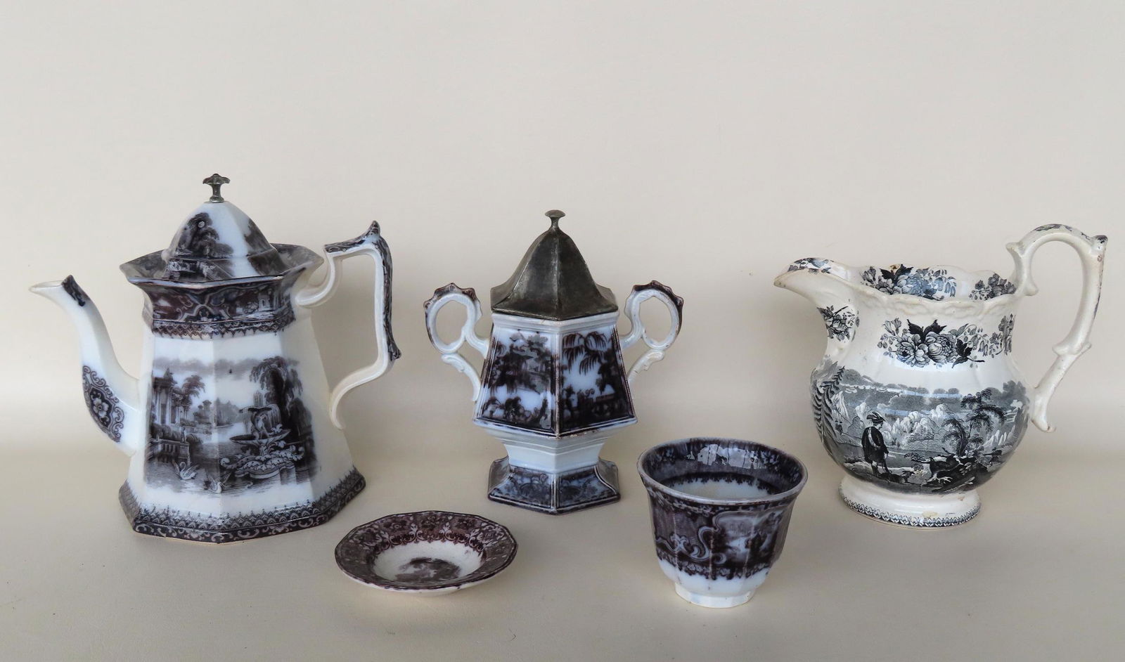 Grouping of 5 pieces of Staffordshire transferware china. The largest, a teapot with a replaced (1 of 10)