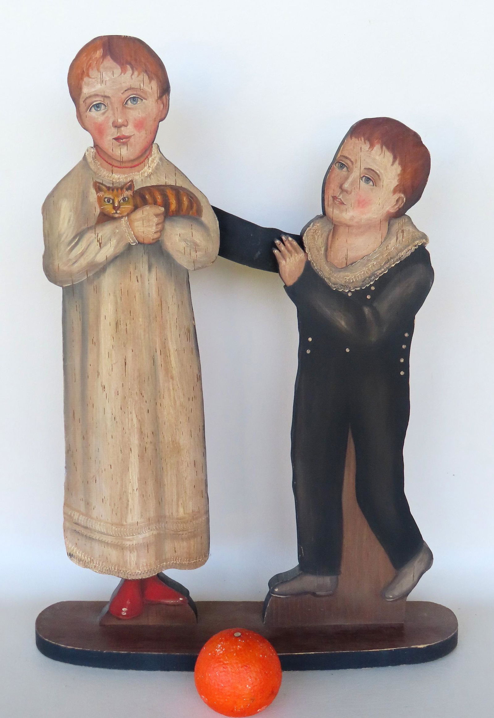 A wooden dummy board depicting 2 children, one holding a tiger cat, all hand made and hand painted, (1 of 4)