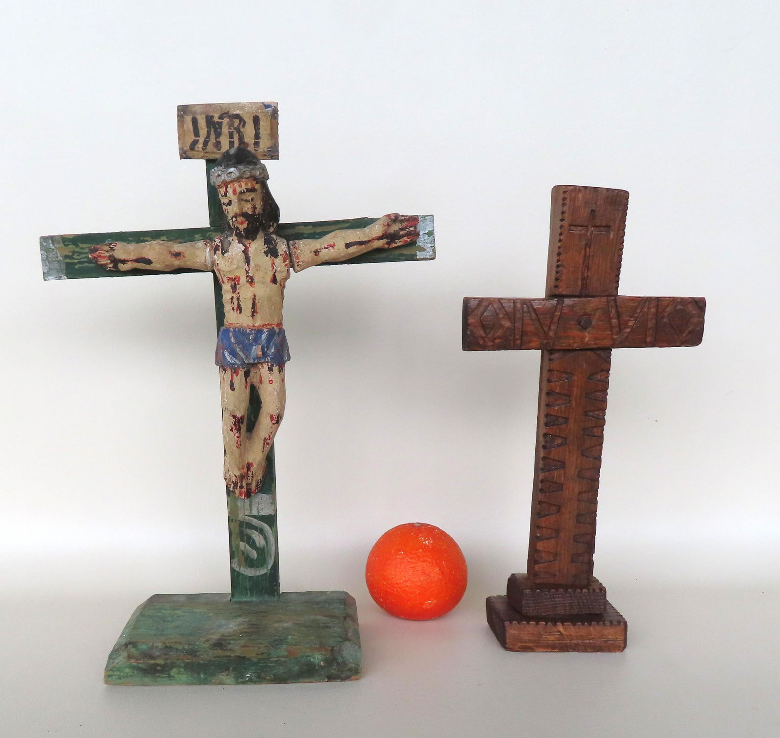 Two crucifixes, both probably Central America, late 19th to early 20th century. The smaller in: Two crucifixes, both probably Central America, late 19th to early 20th century. The smaller in natural finish measures 12 1/4" H x 6 1/4"W - very good condition. The larger, carved and polychrome wood