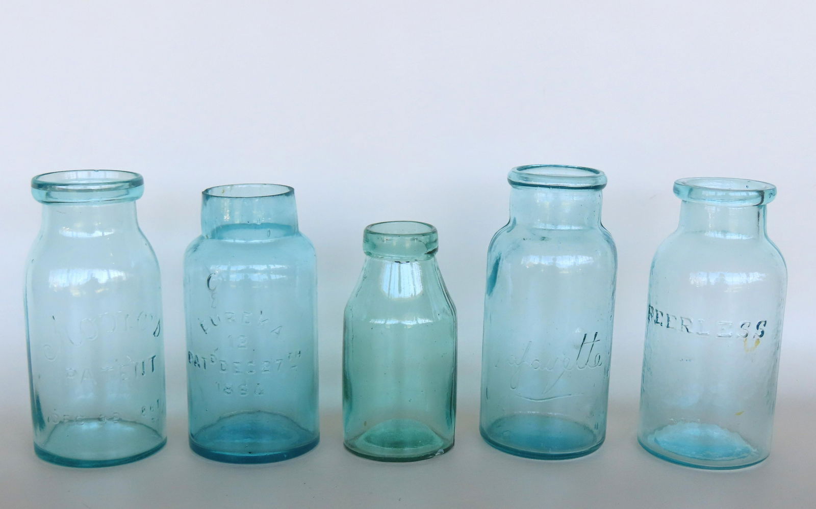 Five wide mouth fruit jars missing lids, including: An aqua colored jar - slight chip on edge of (1 of 12)