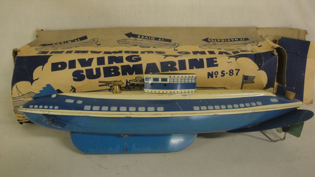 Woverine submarine in original box plus a plastic w: Woverine submarine in original box plus a plastic windup motor boat.