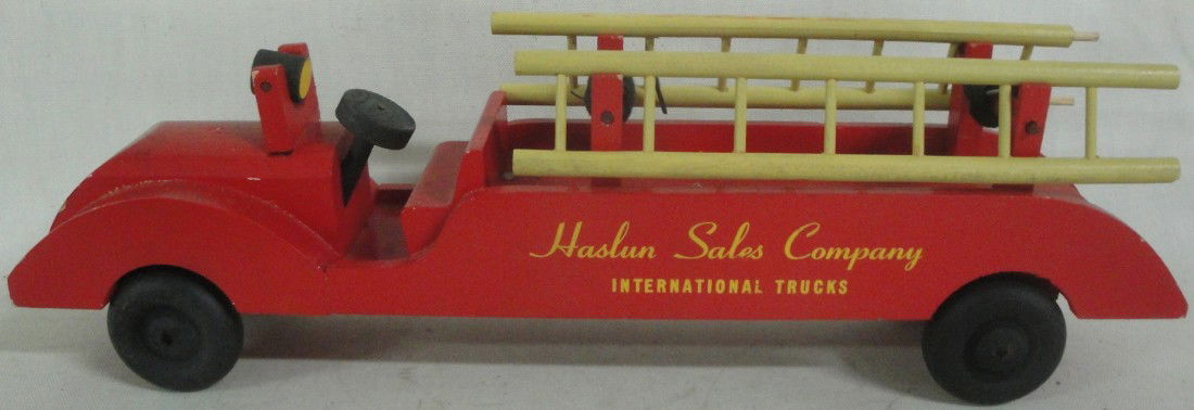 Two toy firetrucks including Haslun Sales Co. hook: Two toy firetrucks including Haslun Sales Co. hook and ladder and a diecast hook and ladder #473 in original box signed Hubley