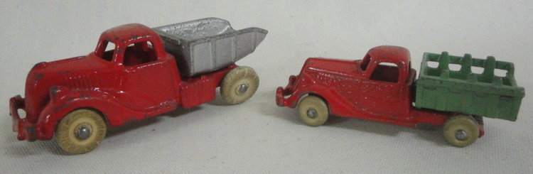 Four early miniature cast iron toys inc. farm trac: Four early miniature cast iron toys inc. farm tractor, two dump trucks and blacktop roller (NOTE: roller toy with wooden wheels missing head of driver) - 3.5"-4.5"