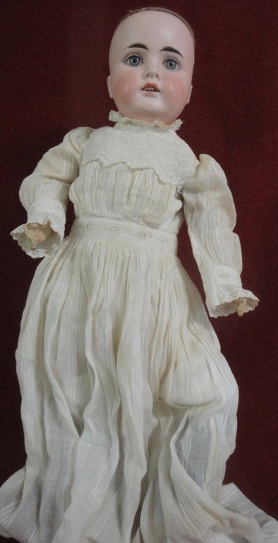 German doll - marked No. 10 - 22" h - plaster over: German doll - marked No. 10 - 22" h - plaster over wood jointed body - open mouth with chipped tooth - pierced ears - one of the 2 small holes at top of head with chips.