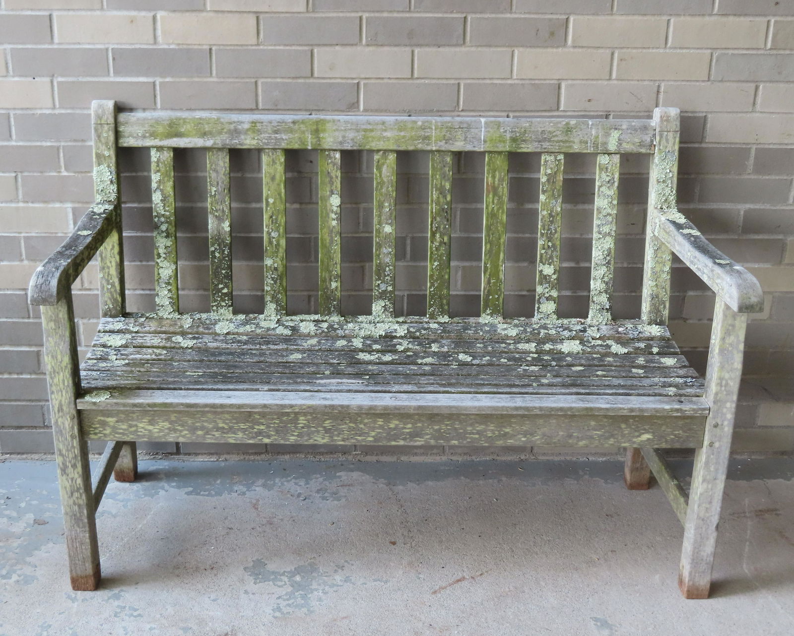 A teakwood garden bench covered with lichen as found in the garden of a beautiful Connecticut (1 of 7)