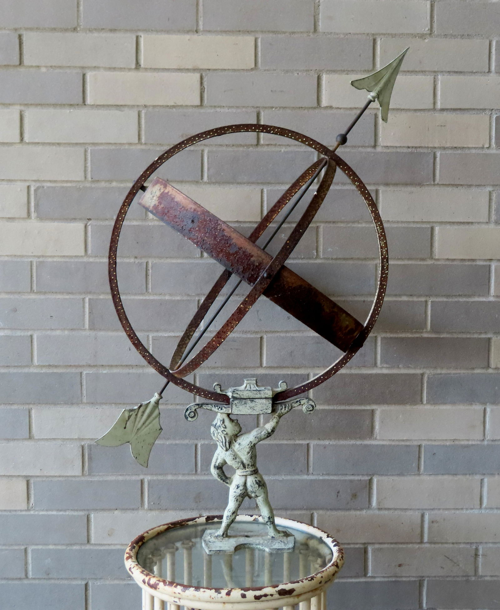 An armillary metal sphere held by a figure of Atlas - the sphere is construction of iron having (1 of 7)