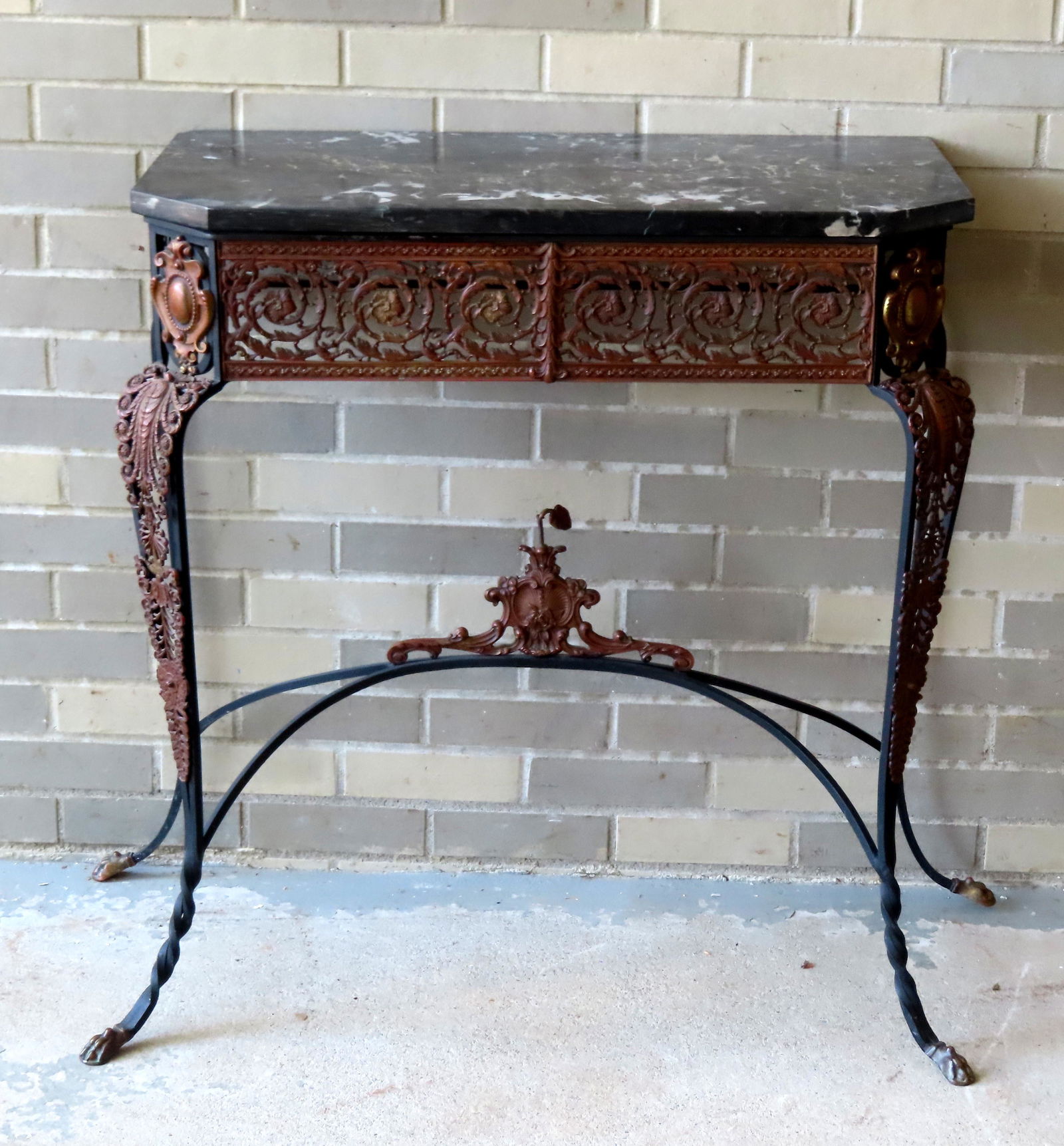 A very ornate wrought iron and bronze console table with shaped marbleized gray/black marble top. (1 of 10)