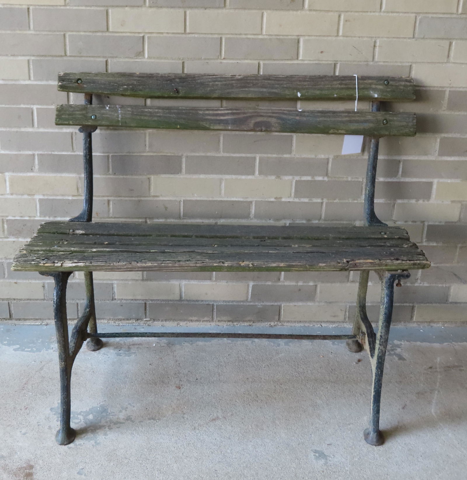 Small wrought iron park bench with horizontal wooden slats on seat and back - most slats worn and (1 of 3)