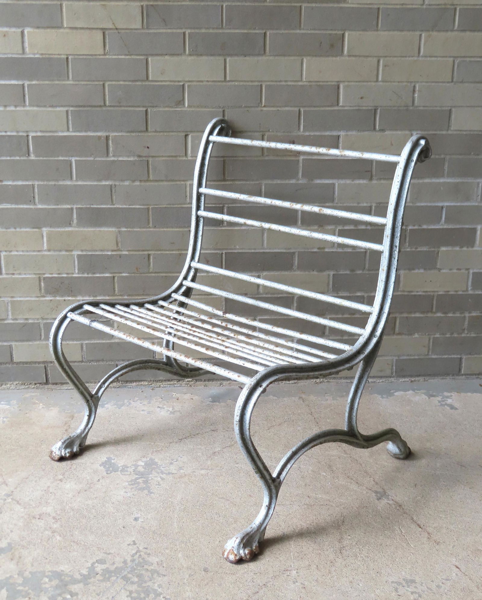 A heavy cast iron garden chair with scrolled frame, and legs leading to hairy paw feet,  mid 19th (1 of 8)