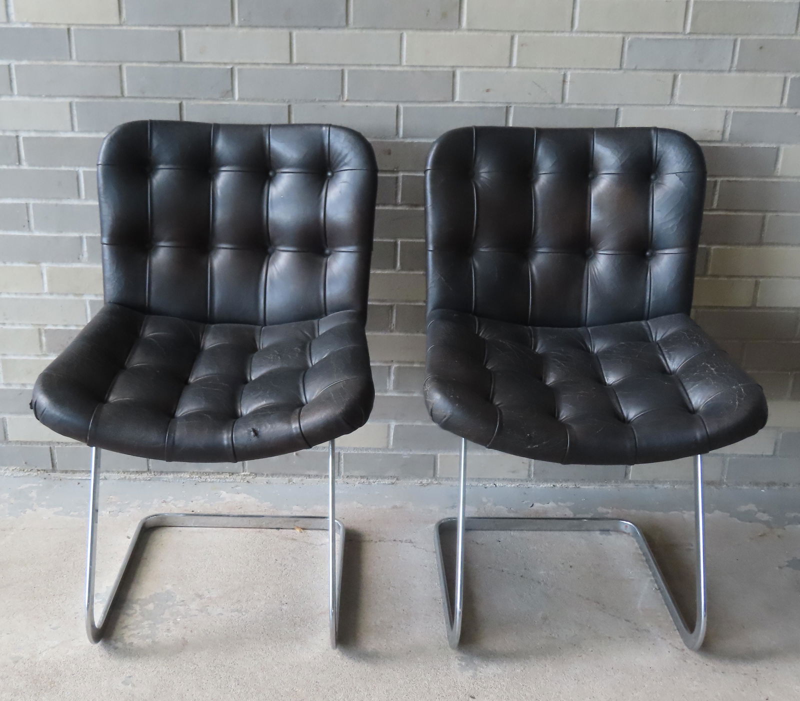 Robert Haussmann, Swiss furniture designer, 20th century . A pair of mid-century modern tufted: Robert Haussmann, Swiss furniture designer, 20th century . A pair of mid-century modern tufted leather chairs with shaped chrome frames, circa 1959 - label on reverse marked "Imported by Stendig Inc."