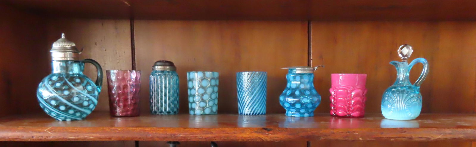 Grouping of 8 pieces of colorful Victorian glass including 2 syrups in opalescent blue one with (1 of 9)