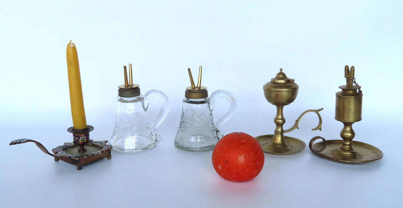 Four early fluid/whale oil lamps, 19th century, together with a champleve chamber stick (measures 6 (1 of 12)