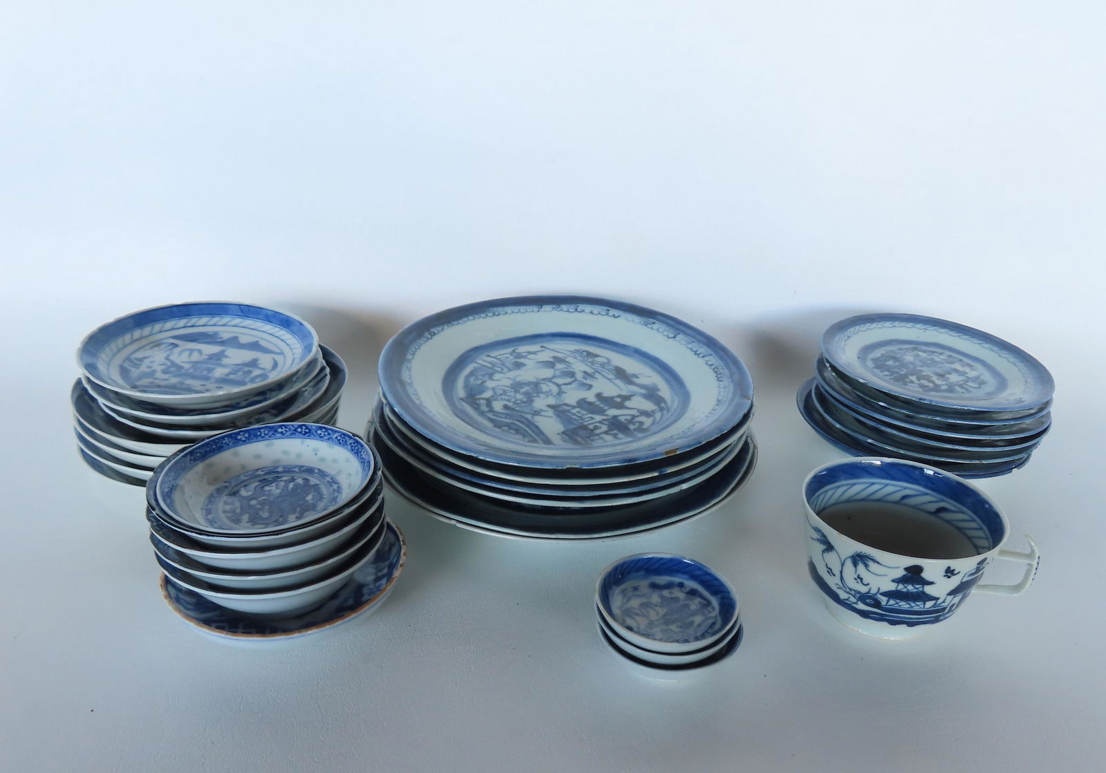 A grouping of 29 pieces of mostly Canton china including plates, saucers, and Japanese sake cups. (1 of 11)
