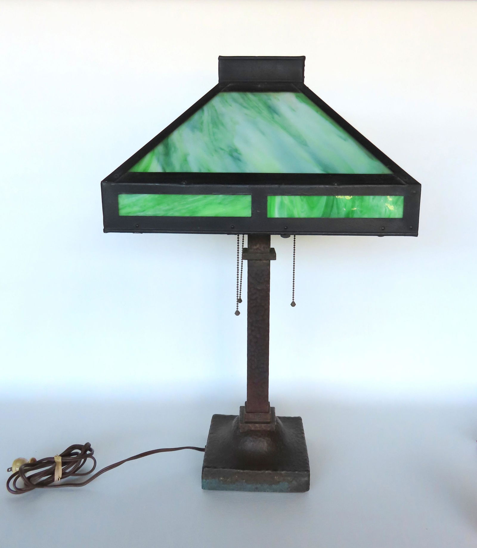 An Arts and Crafts slag glass table lamp with 4 sides with green slag glass and painted tin frame. (1 of 10)