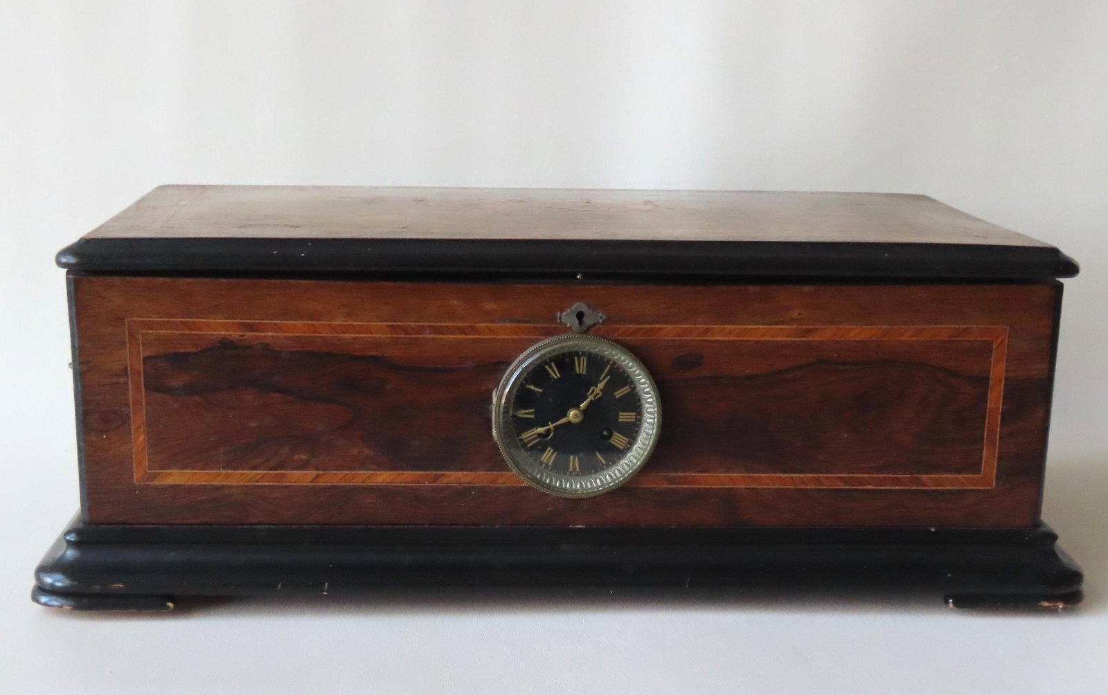 An unusual Victorian Swiss 8 airs rosewood Mandolin music box with inlays and built in windup clock: An unusual Victorian Swiss 8 airs rosewood Mandolin music box with inlays and built in windup clock mounted to front panel, 19th century. The box also with fancy brass handles attached to sides. The c