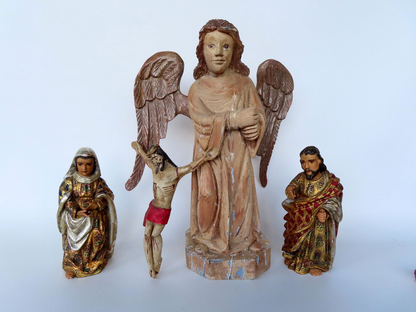 Grouping of 4 Spanish hand carved religious sculptures including a large angel with glass eyes (1 of 9)