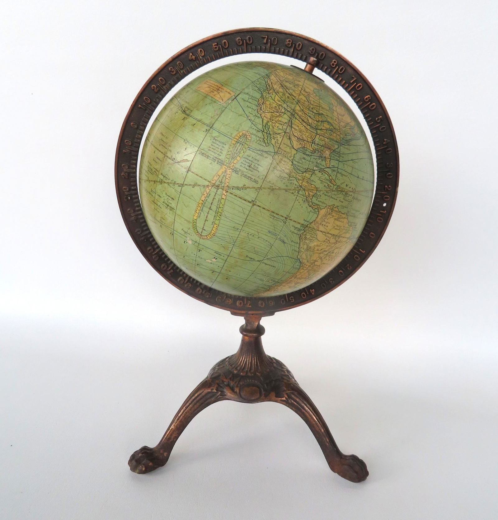 Terrestrial globe on cast iron tri-foot base with claw feet and having a bronze finish. The globe (1 of 7)