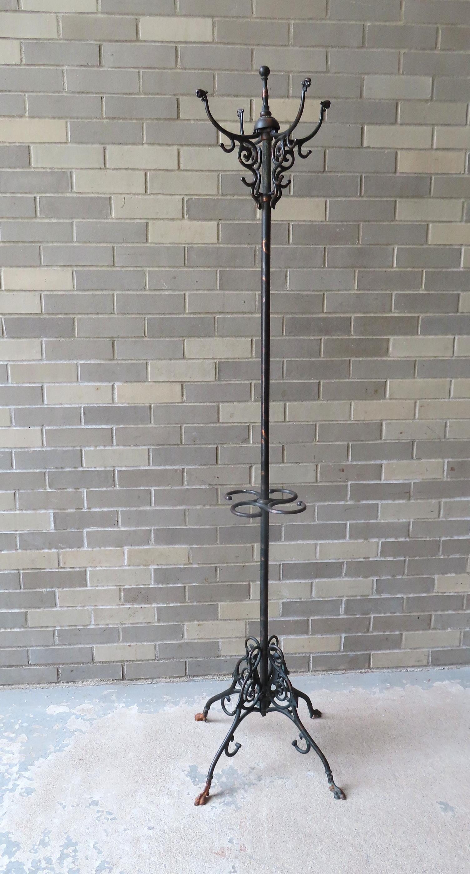 A cast iron hall tree in grain paint having 4 coat hooks at top with lion head terminals, over 4 (1 of 5)