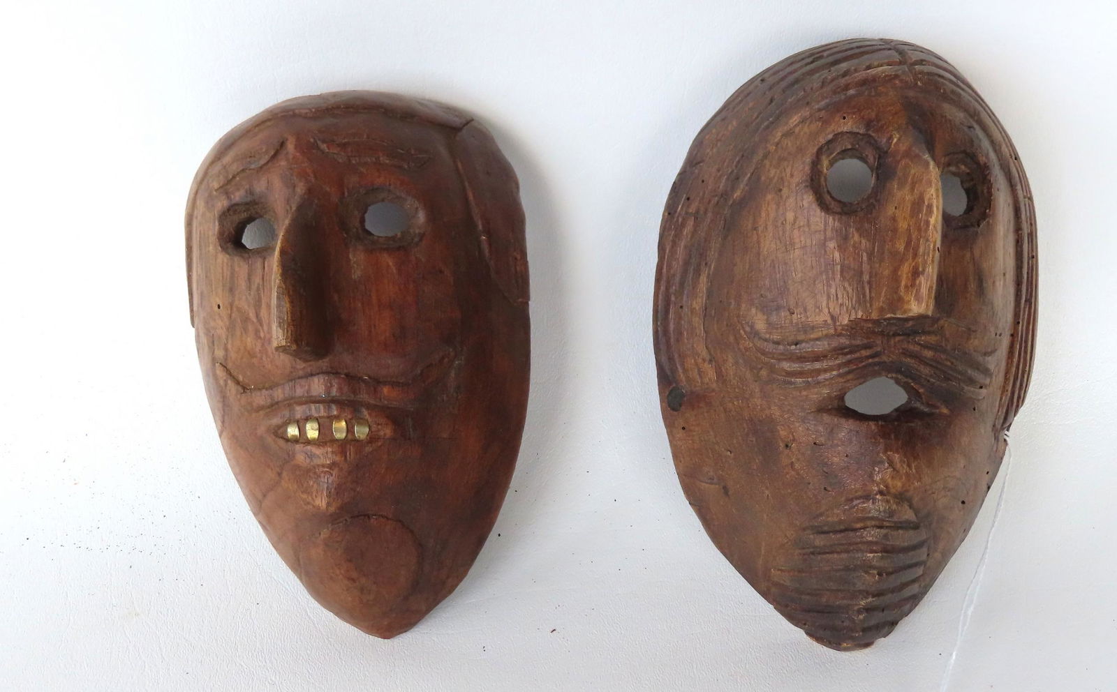 Two small hand carved ethnographic masks, dated on interior 1944 and 1946, probably brought back to (1 of 2)