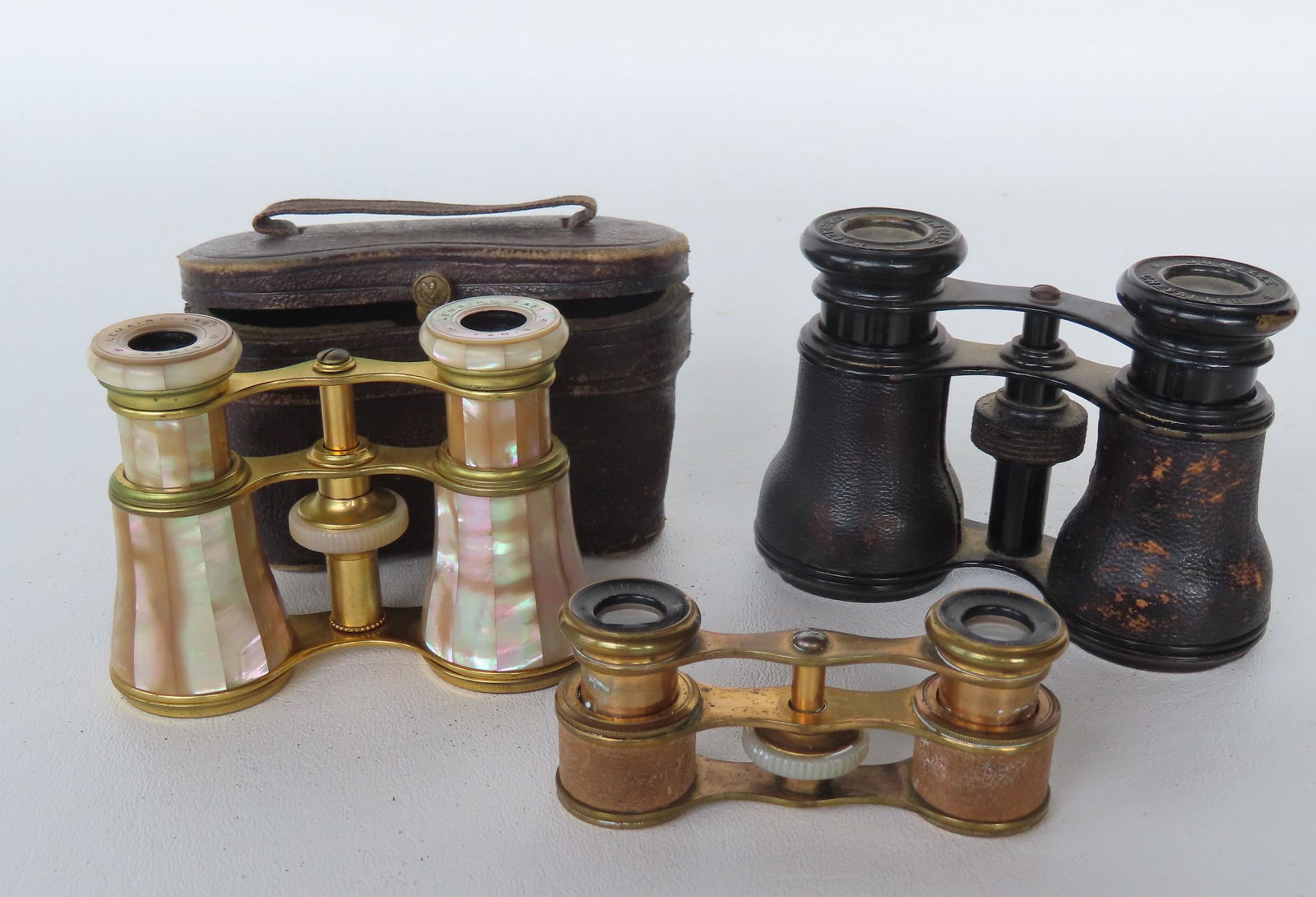 Three pair of opera glasses including: 1) Brass and mother-of-pearl marked "Lemaire Fabt / Paris" (1 of 7)