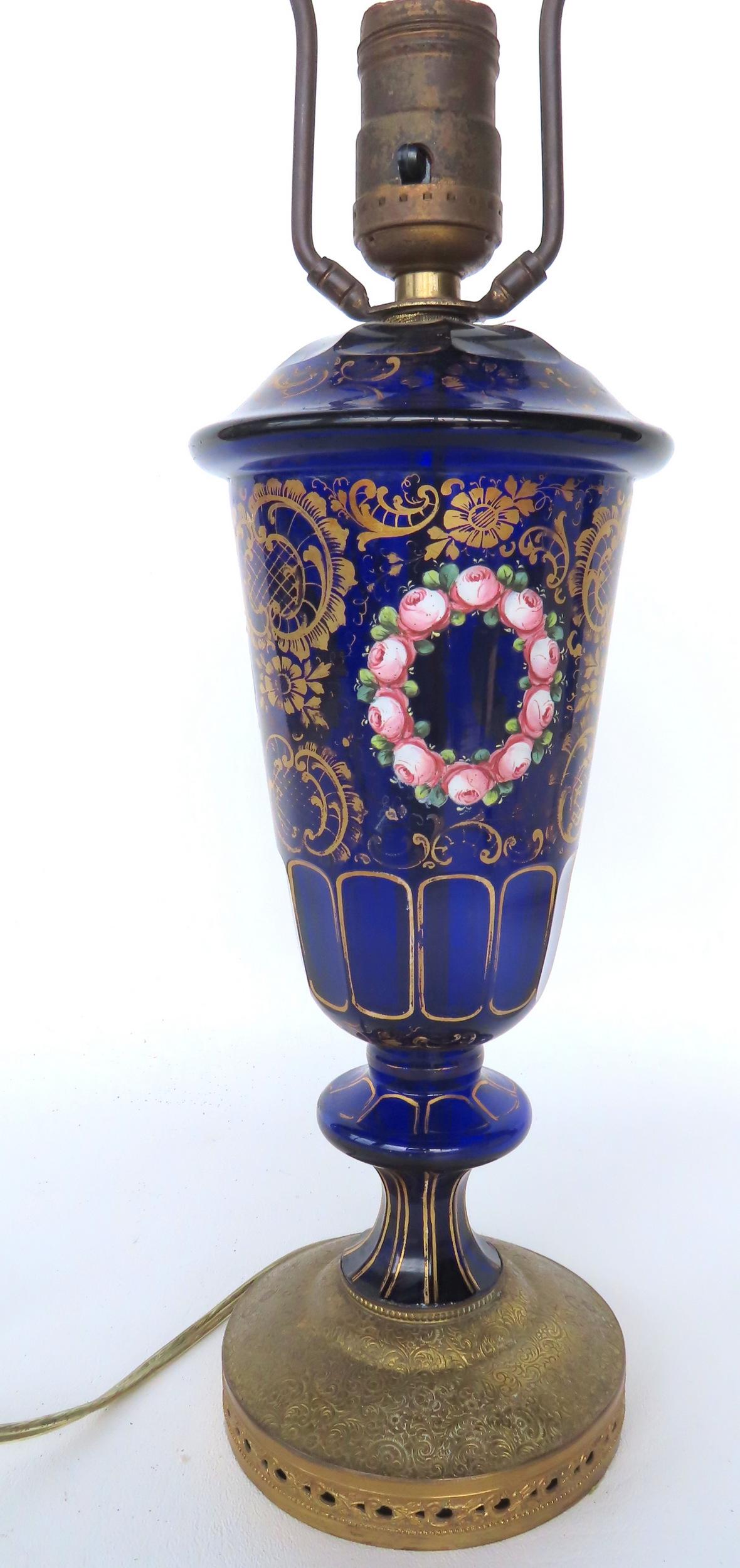 An ornate cobalt blue table lamp decorated with rings of pink flowers and extensive gilt work (1 of 6)