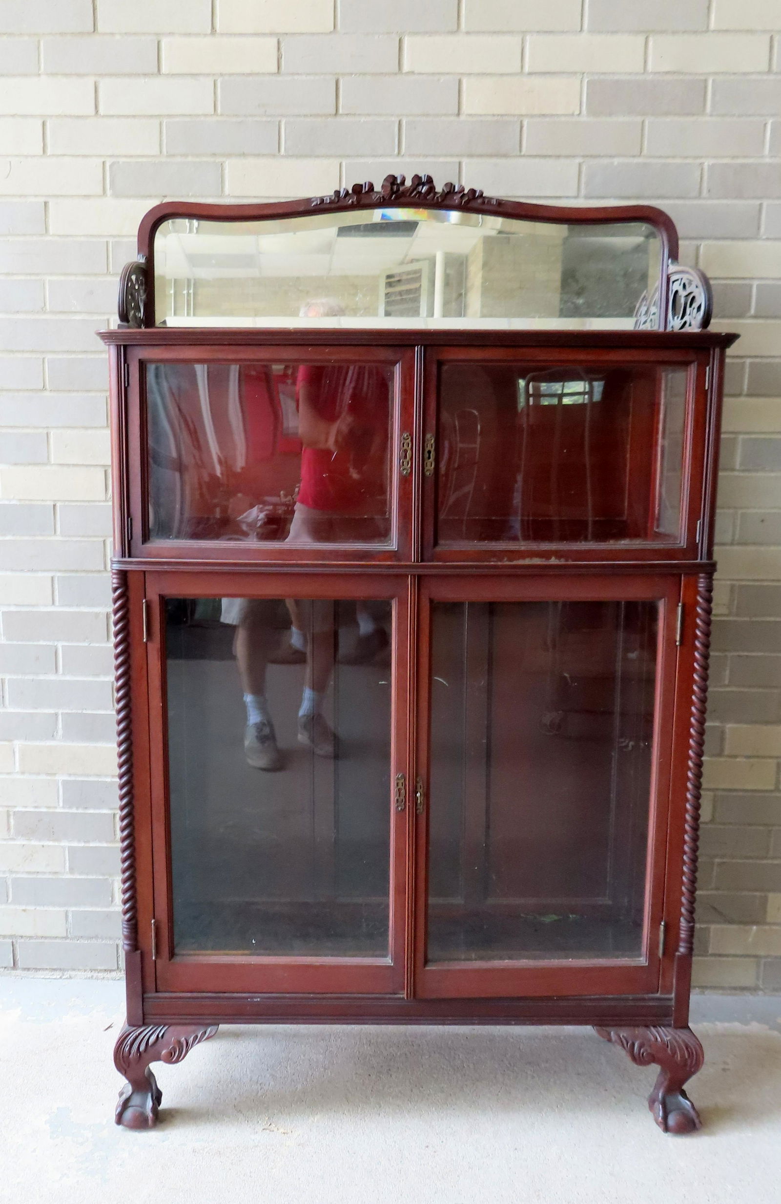 An ornate 4 door mahogany bookcase having a mirrored backsplash over 2 slightly bowed short glass (1 of 7)