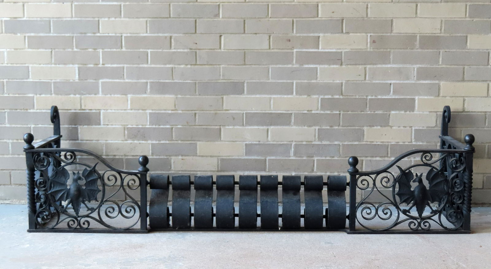 Unusual cast iron gothic fireplace fender, decorated with scrolls and spread-wing bats, late 19th to (1 of 6)