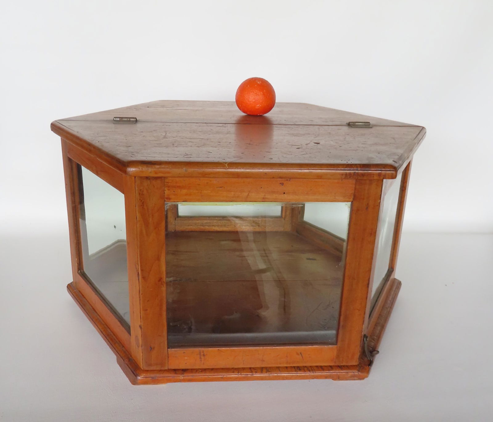 An unusual hexagonal table top glass showcase with maple frame. The front 1/2 of the showcase lifts (1 of 6)