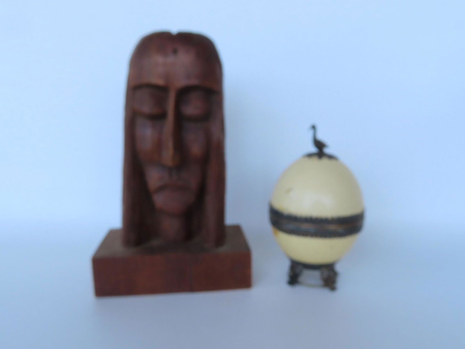 Two decorative objects including: A modernistic wooden sculpture of Jesus, circa 1950, missing: Two decorative objects including: A modernistic wooden sculpture of Jesus, circa 1950, missing crown of thorns, else very good condition - 13"H x 8"W x 4 1/2"D; combined with an ostrich egg container