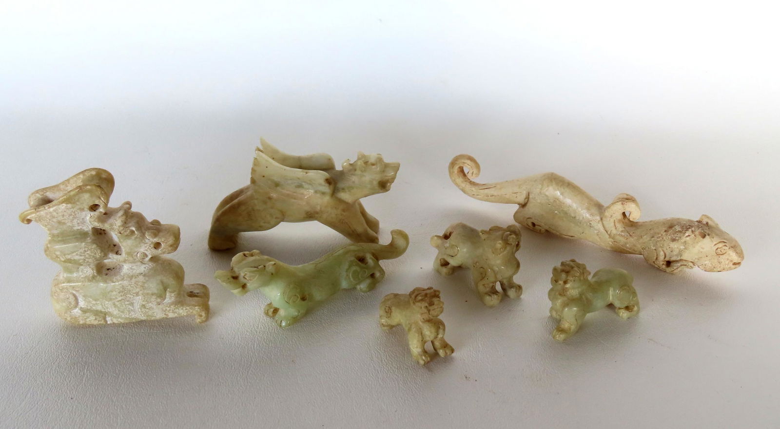 Grouping of 7 miniature oriental carved animals and dragons, some are likely stone Chinese toggles (1 of 16)