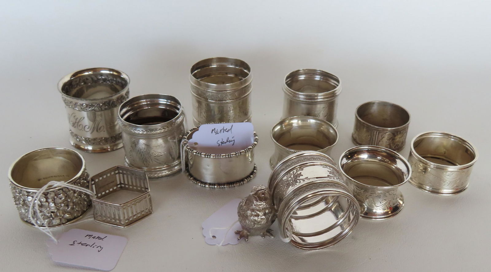 Grouping of 13 non-matching silver napkin rings, most Victorian era, 5 marked sterling weighing 4.2 (1 of 3)
