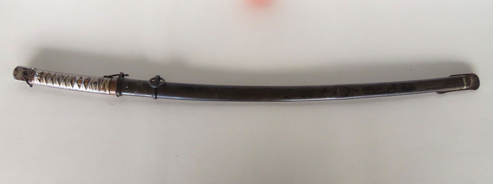 A Japanese NCO Samurai sword with scabbard (note - non-matching serial numbers on sword - 16982 and (1 of 14)